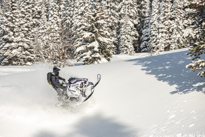 a man riding skis down a snow covered slope