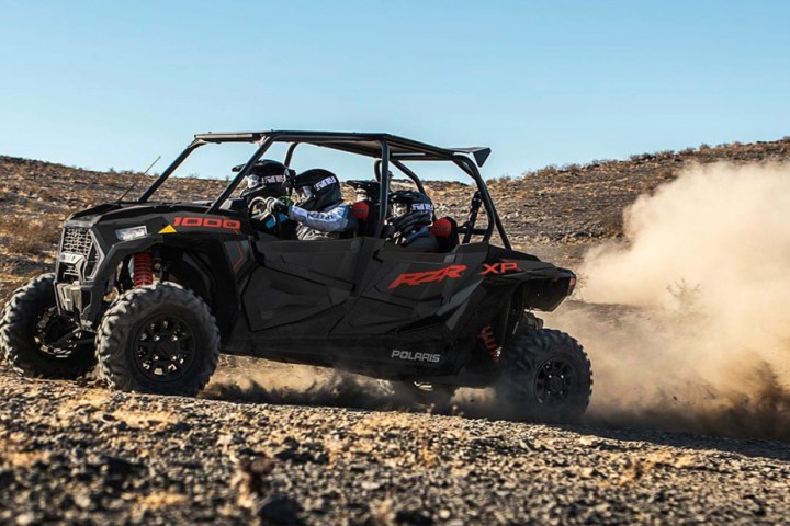 a car driving down a dirt road